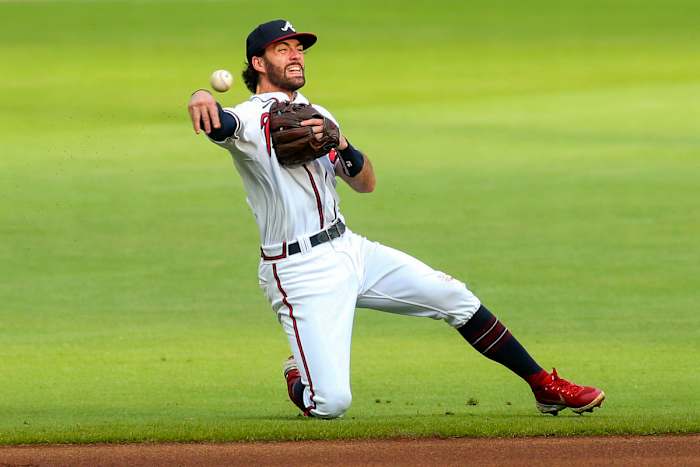 Braves shortstop Dansby Swanson throws to first base.
